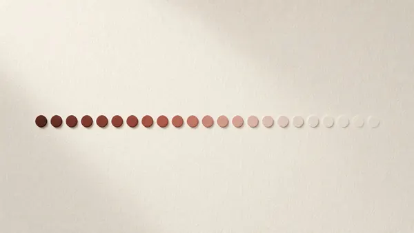 A row of dots fading from deep brown to pale pink